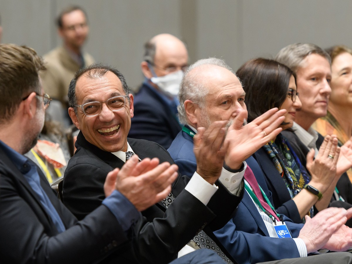 People in the audience of a presentation clapping