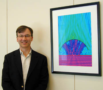 Eric Heller stands beside one of his creations at APS Headquarters. (Photo by Barrie Ripin)