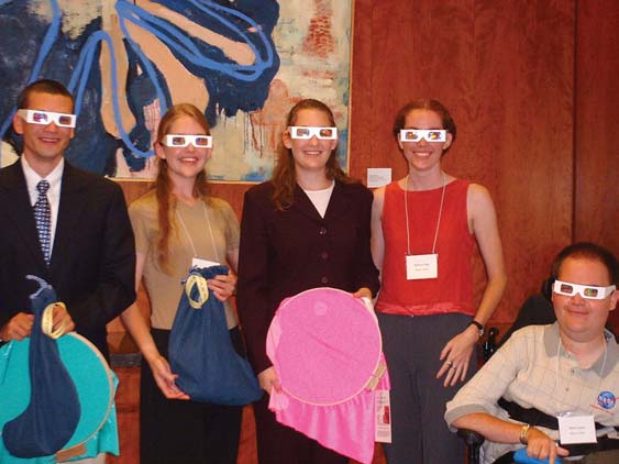 The 2002 SPS summer interns at their closing session on August 13. The group is modeling the light diffracting glasses and holding equipment that is part of the educational SPS Outreach Catalyst Kit (SOCK) Tabeling and Glas put together. From left to right: Jason Tabeling, Lauren Glas, Eva Wilcox, Katie Peek, and Brent Janus.