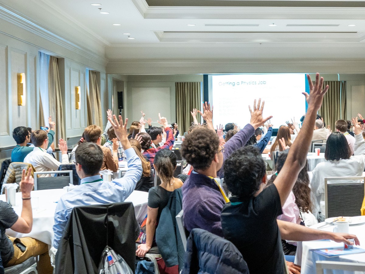 Student attendees raising their hands at an APS event