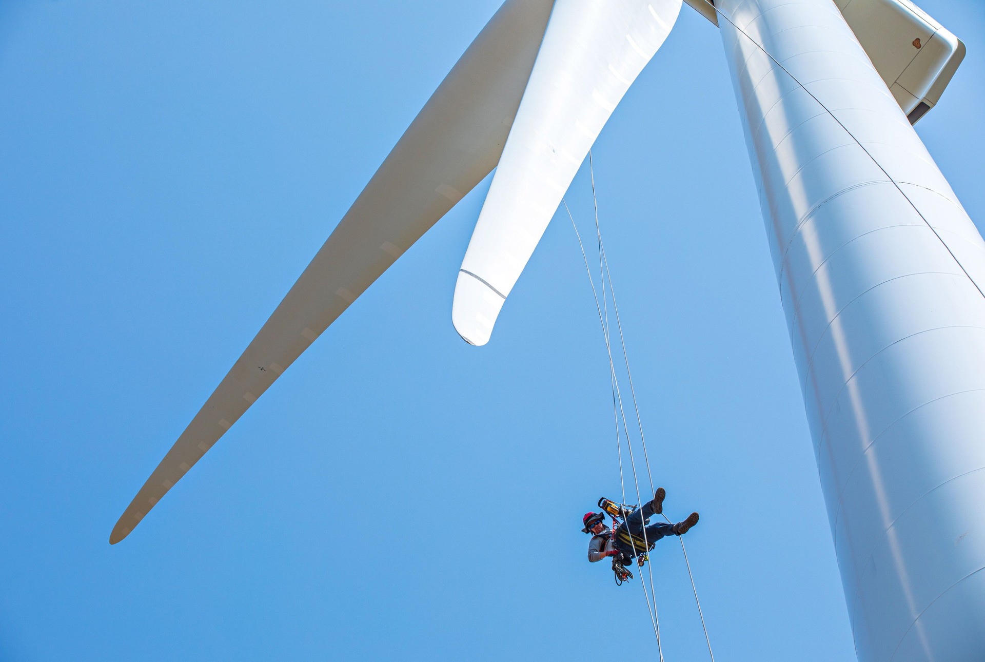 A technician checks a wind turbine at the National Renewable Energy Laboratory