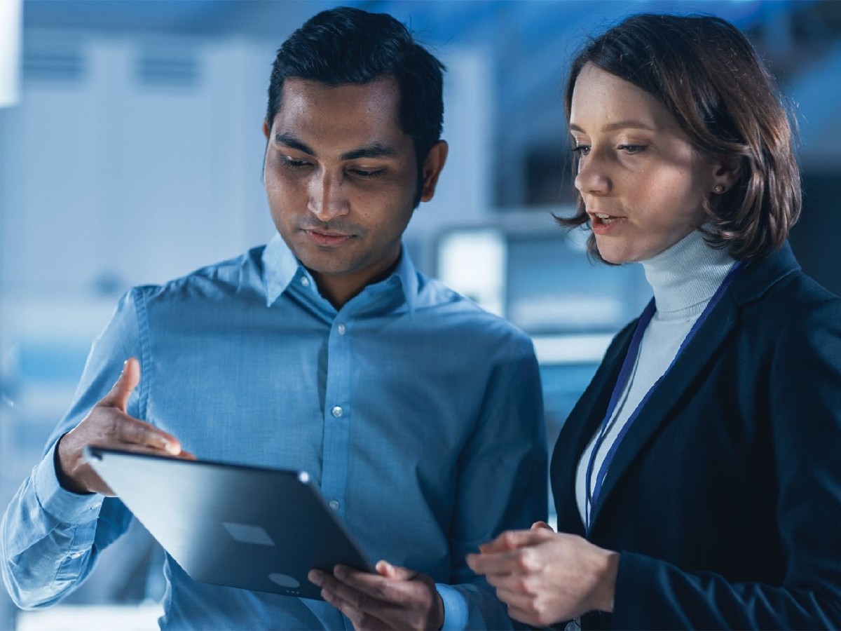 Two people in a lab, looking at a tablet together