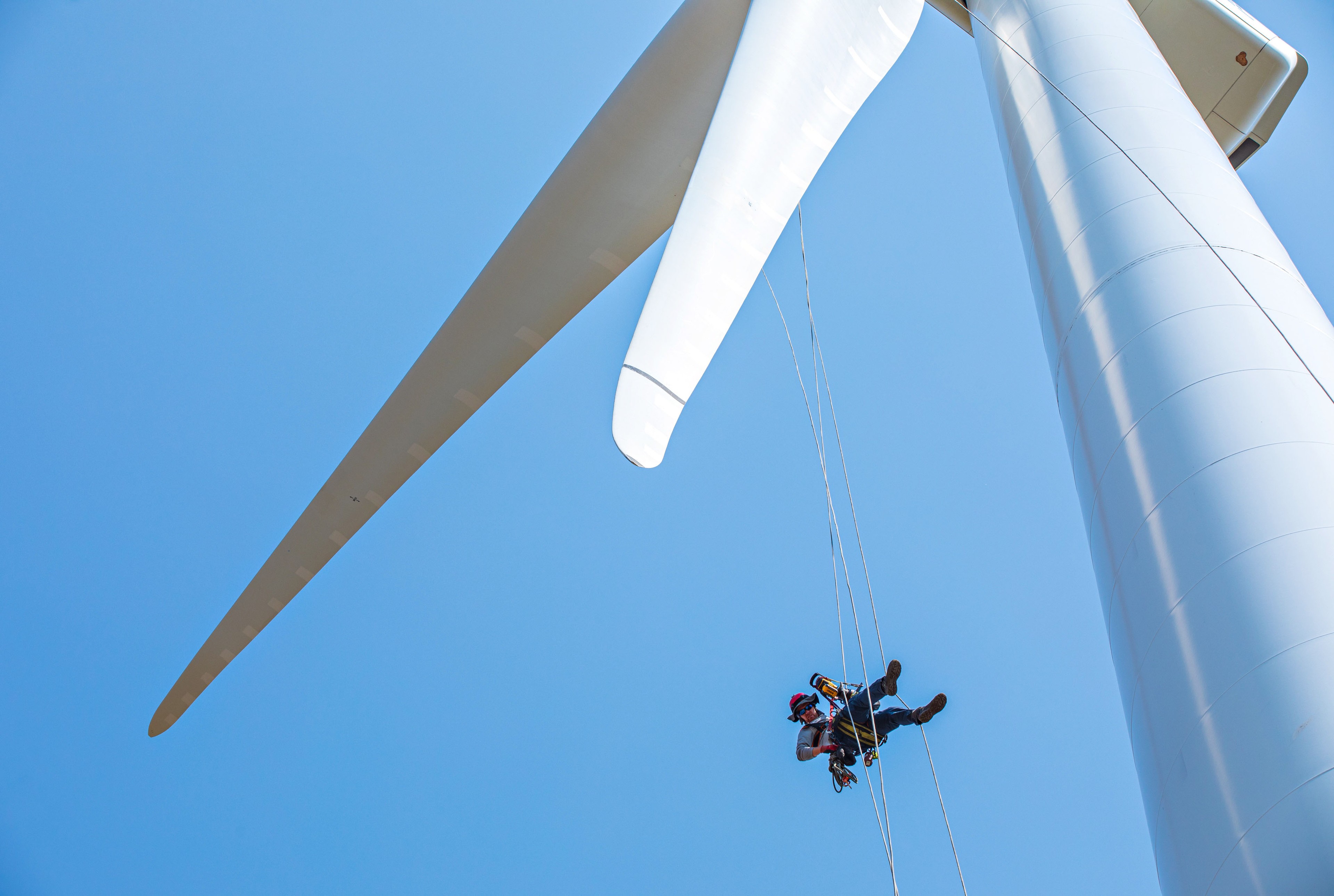 A technician checks a wind turbine at the National Renewable Energy Laboratory