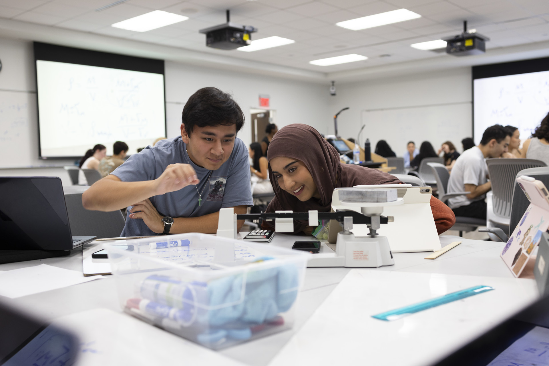 Two students in a physics class working together 