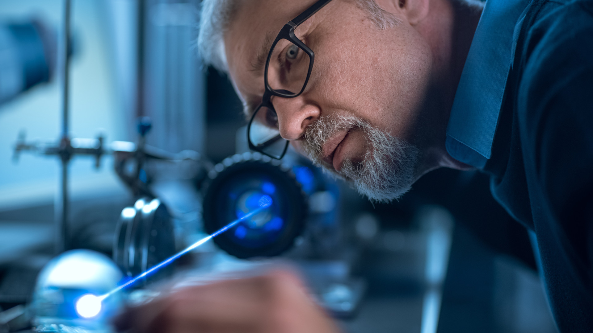 A man examines high-precision laser equipment