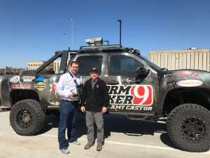 Brian Elbing (left) holds a microphone with storm chaser Val Castor (right) in front of his storm chasing truck, in which the researchers mounted an infrasound sensor for monitoring tornadoes. Credit: Brian Elbing.