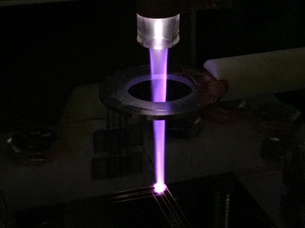 A laser light going through a metal ring