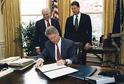 Jack Gibbons watching President Clinton signing